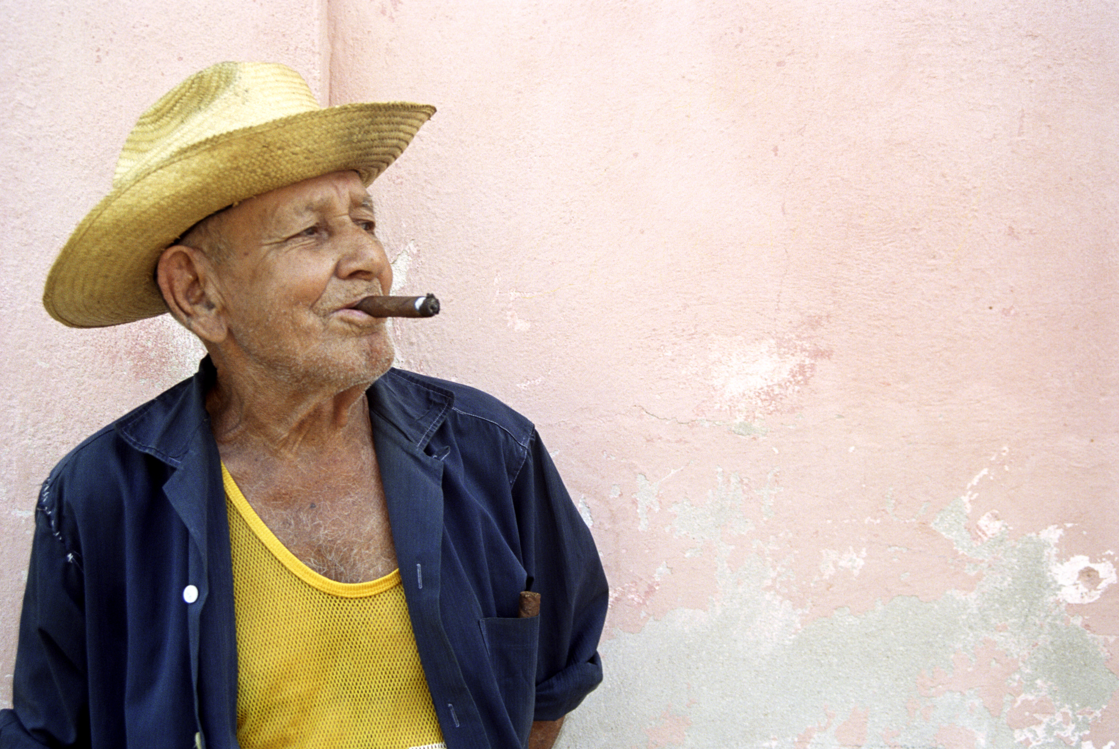 200428157-001 Cuba, Trinidad, senior man smoking cigar, looking away